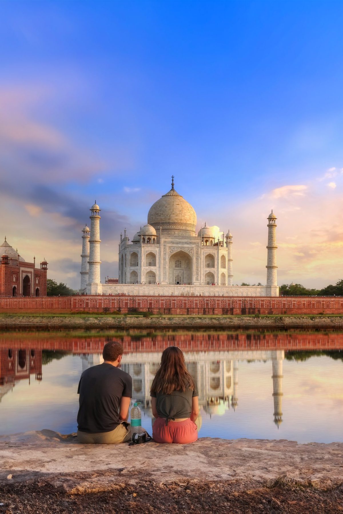 Taj Mahal Agra at sunset with moody sky and water reflection enj